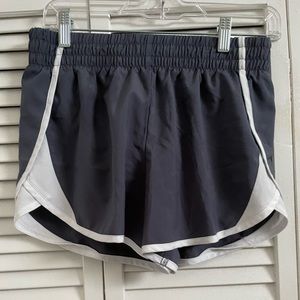 The grey and white athletic shorts are a size XL.